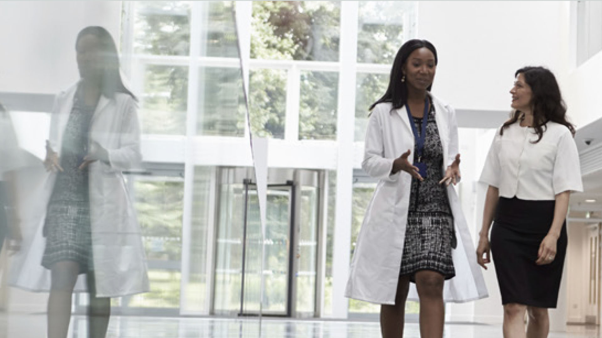 Healthcare professionals walking through a modern medical office building